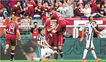  ?? Reuters ?? On target Torino’s Fabio Quagliarel­la is mobbed by his teammates after scoring against Juventus during their Italian Serie A match at the Olympic Stadium in Turin on Sunday.