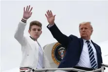  ?? Associated Press ?? President Donald Trump, right, and his son Barron Trump wave Aug. 16 from the top of the steps to Air Force One at Morristown Municipal Airport in Morristown, N.J.