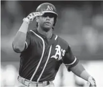  ?? Hannah Foslien, Getty Images ?? The Athletics’ Khris Davis celebrates as he rounds the bases after hitting a solo home run against the Twins on Thursday at Target Field in Minneapoli­s.