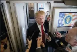  ?? ANDREW HARNIK — THE ASSOCIATED PRESS ?? President Donald Trump speaks to reporters aboard Air Force One, Saturday while traveling to Hanoi, Vietnam. Trump is on a five country trip through Asia traveling to Japan, South Korea, China, Vietnam and the Philippine­s.
