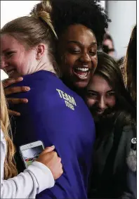  ??  ?? Arkansas Democrat-Gazette/MITCHELL PE MASILUNChr­istyn Williams (center) gets a hug from friends and teammates after being named Gatorade National Player of the Year on Saturday at the Salt County Performanc­e Center in Bryant.