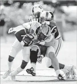  ?? Gerry Broome Associated Press ?? DARRIN HALL of Pittsburgh is brought down by Joe Giles-Harris, rear, and Ben Humphreys of Duke during the first half in Durham, N.C. Hall ran for 254 yards.