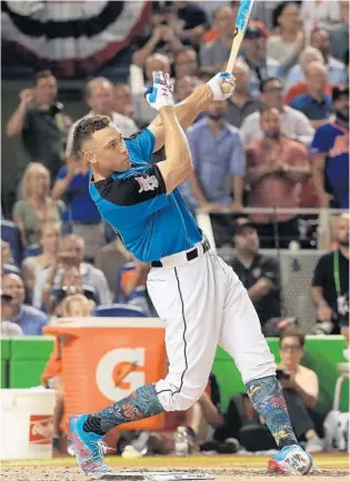  ?? MIKE EHRMANN/GETTY IMAGES ?? Yankees young star Aaron Judge used a 30-second bonus to finish with 23 homers in the opening round Monday night and advance in the Home Run Derby on the way to the crown in Marlins Park.
