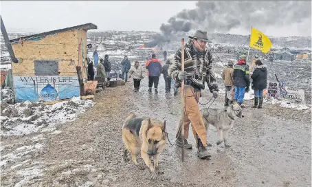  ?? TOM STROMME/THE BISMARCK TRIBUNE VIA THE ASSOCIATED PRESS ?? Opponents of the Dakota Access pipeline leave their main protest camp Wednesday, near Cannon Ball, N.D. Oil could be flowing through the pipeline as soon as March 6, as American Indian tribes continue fighting in court.