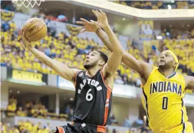  ??  ?? Cory Joseph, de los Raptors de Toronto, anota dos puntos luego de eludir la defensa de C.J. Miles, delantero de los Pacers de Indiana.