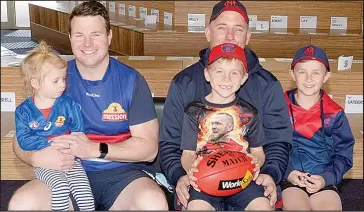  ??  ?? Sacred Heart Primary School teacher Daniel Boulton and daughter Tilly, and Ben Lawless with sons Todd and Aiden, agreed to disagree on the outcome of the big game this Saturday night.