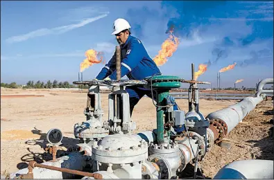  ?? AP ?? An Iraqi works in an oil field north of Basra. Oil revenue makes up nearly 95 percent of Iraq’s budget.