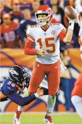  ?? GETTY ?? Patrick Mahomes tosses left-handed pass to help bring Chiefs back.