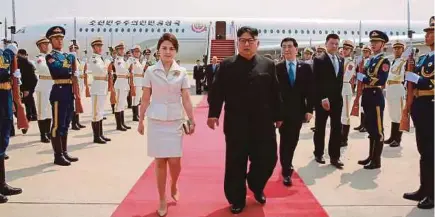  ?? AFP PIC ?? North Korean leader Kim Jong-un with his wife, Ri Sol-ju (left), arriving at a Beijing airport on Tuesday. Kim is in the Chinese capital for a summit with President Xi Jinping.