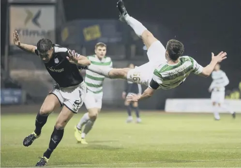  ??  ?? 0 Celtic defender Tony Ralston is airbound following a challenge from Dundee captain Darren O’dea during the Betfred Cup quarter-final.