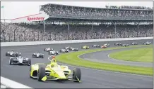  ?? DARRON CUMMINGS — THE ASSOCIATED PRESS FILE ?? Simon Pagenaud leads the field through the first turn on the start of the 2019 Indianapol­is 500. There will be no fans at the 2020 running of the 500.