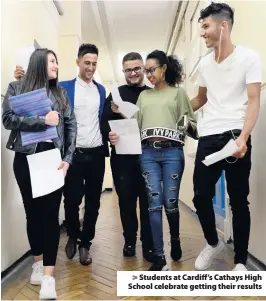  ??  ?? &gt; Students at Cardiff’s Cathays High School celebrate getting their results