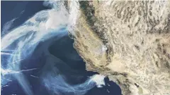  ?? PHOTOS: REUTERS ?? View from space . . . A Nasa Terra satellite image shows smoke continuing to spread west from the Camp Fire and two more fires, the Hill and Woolsey Fires in southern California.