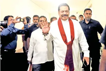  ??  ?? Rajapaksa waves as he arrives at the parliament in Colombo, Sri Lanka. — Reuters photo