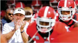  ?? CURTIS COMPTON/AJC 2018 ?? Kirby Smart and Georgia players take the field in April 2018 for that year’s annual G-day spring intrasquad football game in Athens.