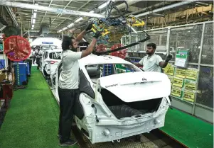  ?? ?? Employees work in an assembly line at an atuomobile factory near the southern Indian city of Chennai. A Goldman Sachs report has predicted that India’s economy is on track to surpass the US by 2075. — afp