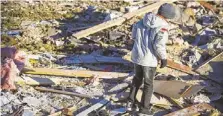  ?? PHOTOS BY AP ?? Brady Klein, 11, walks through the rubble of his family’s home in Washington, Ill., after it was leveled Nov. 17 by a tornado.