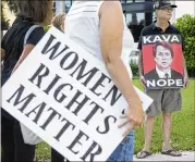  ?? MELANIE BELL / THE PALM BEACH POST ?? Bruce Brown of Lake Worth brought an anti-Kavanaugh sign to the demonstrat­ion Sunday at the FBI offices on Flagler Drive. A security guard tried unsuccessf­ully to move the rally down the road to the Trump Plaza Office Center.