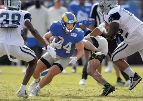  ?? John McCoy Associated Press ?? JAKE FUNK (34), shown against Dallas in a scrimmage, is hoping to be a part of the Rams’ running back rotation this season.