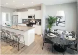  ??  ?? The open-concept kitchen and dining area in the Juno show home by Homes by Dream in Vista Crossing.