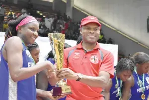  ??  ?? The Group Managing Director of Zenith Bank, Peter Amangbo (R) presents the winners’ trophy to captain of First Bank Basketball Club Nkechi Akashili at the National Stadium Lagos yesterday