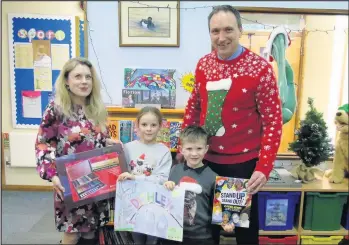  ??  ?? ■ Pictured, left to right: Charnwood Borough councillor, Coun Emma Ward, winners Isla and Zachary Beresford and the headteache­r of Stonebow Primary School, Paul Brockless.