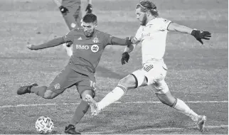  ?? DAVID BUTLER II • USA TODAY SPORTS ?? Nashville SC’S Walker Zimmerman, right, defends against Toronto FC midfielder Alejandro Pozuelo during the second half of MLS playoff action on Tuesday in East Hartford, Conn.