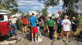  ?? SARAH FRANKS / STAFF ?? More than 100 University of Dayton student volunteers and 150 total volunteers worked Saturday in Old North Dayton near Valley Street to continue cleanup efforts following the Memorial Day tornadoes.