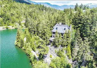  ??  ?? Chateau du Lac in Whistler is a five-bedroom property with 1,000 feet of lake frontage previously listed at $19.8 million. The 9,940-square-foot property is being auctioned online and live Dec. 20 in Hong Kong.