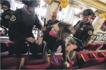  ?? THOM BRIDGE/INDEPENDEN­T RECORD VIA AP ?? Law enforcemen­t forcibly clear the Montana House of Representa­tives gallery during a protest on Monday in the state Capitol in Helena.