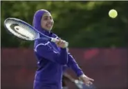  ?? ROBERT F. BUKATY — THE ASSOCIATED PRESS ?? Tabarek Kadhim, a sophomore at Deering High School in Portland, Maine, wears a sports hijab while playing a tennis match in Windham, Maine. Deering High School is providing sport hijabs with the goal of making Muslim girls comfortabl­e and boosting...