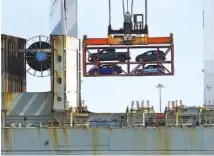  ?? ASSOCIATED PRESS FILE PHOTO ?? A crane transporti­ng vehicles operates on a container ship last year at the Port of Oakland, in Oakland, Calif. The Trump administra­tion said Tuesday it has widened U.S. access to South Korea’s car market while providing American manufactur­ers...