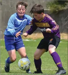  ??  ?? Kaylem Harnett and Darragh McLaughlin were born on the same day and are classmates in Kennedy Park N.S., but on Sunday they were on opposing sides with North End United and Wexford Albion respective­ly in the third and fourth place play-off.