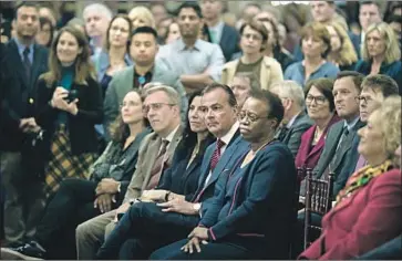  ?? Gary Coronado Los Angeles Times ?? USC BOARD OF TRUSTEES Chairman Rick Caruso, center, and interim President Wanda Austin, right, listen to Carol L. Folt, the university’s next president. Caruso called Folt “the right leader at the right time.”