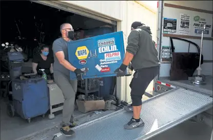  ?? Photos by Deborah Swearingen / Staff Writer ?? Bryan Weatherly, left, and Ifrain Rodriguez help carry an item onto the moving truck Saturday as they help Greg Meyers move from Lyons to Pueblo.