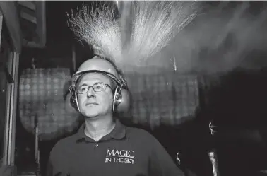  ?? Ronald Cortes / Contributo­r ?? Jacob J. Dell, owner of San Antonio pyrotechni­cs company Magic in the Sky, watches as the June 6 fireworks show begins at Six Flags Fiesta Texas. His company lights up the sky over six states.