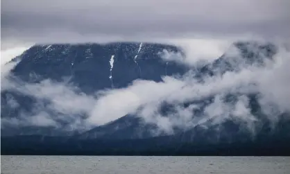  ??  ?? Clouds and rain are seen on Lake McDonald as Glacier national park opens to visitors in June 2020. Photograph: Kent Meireis/Zuma Wire/ Rex/Shuttersto­ck