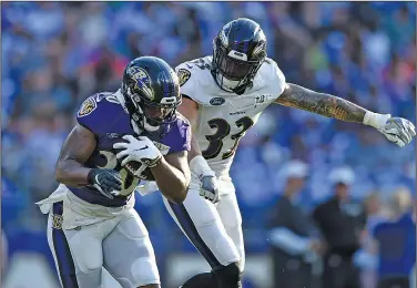  ?? Associated Press ?? Running Strong: Baltimore Ravens running back Kenneth Dixon, a native of Strong, tries to get past Bennett Jackson during NFL football training camp Saturday in Baltimore.