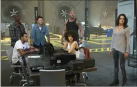  ?? MATT KENNEDY — UNIVERSAL PICTURES VIA AP ?? Chris “Ludacris” Bridges, seated left, and Nathalie Emmanuel, seated right, and Tyrese Gibson, standing from left, Scott Eastwood, Dwayne Johnson and Michelle Rodriguez in “The Fate of the Furious.”