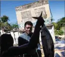  ??  ?? Spearfishe­rman Rick Walker, 35, sells his catch to a buyer at a fish market in White River, Jamaica. Walker remembers the early opposition to the fish sanctuary, with many people saying, “No, they’re trying to stop our livelihood.” Two years later, Walker, who is not involved in running the sanctuary but supports its boundary, says he can see the benefits. “It’s easier to catch snapper and barracuda,” he says. “At least my great grandkids will get to see some fish.”