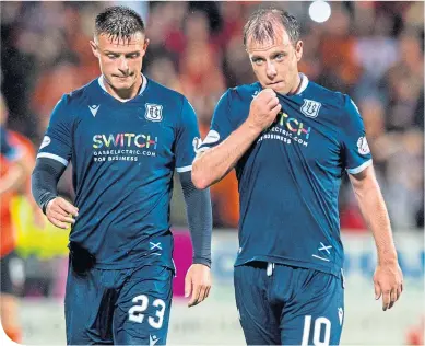  ??  ?? Paul McGowan, right, leaves the Tannadice pitch on Friday night with Jordan Marshall