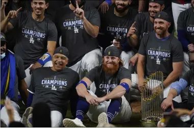  ?? ERIC GAY — THE ASSOCIATED PRESS ?? Dodgers manager Dave Roberts and third baseman Justin Turner pose for a group picture after the Dodgers defeated the Tampa Bay Rays, 3-1, in Game 6 to win the World Series Oct. 27 in Arlington, Texas.