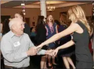  ?? JESI YOST — DIGITAL FIRST MEDIA ?? Kenneth Snyder shows Boyertown Area High School senior Charlotte Calautti a few dance moves at Senior-Senior Prom held at The Center at Spring Street.