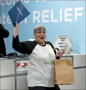  ?? GENE J. PUSKAR — THE ASSOCIATED PRESS ?? Joan Caleodis, of Martin’s Ferry, celebrates being one of the first patient sales of Ohio’s Medical Marijuana program at Cresco Labs CY+ dispensary in Wintervill­e, Ohio. A year after Caleodis became the first person in Ohio to purchase state-sanctioned medical marijuana, she said she remains mostly satisfied with the program but looks forward to a day when prices for cannabis products drop. Caleodis, 56, said she spends around $300a month at local dispensari­es to buy patches along with dried flowers, cannabis oil that she vapes to help treat primary progressiv­e multiple sclerosis.