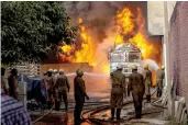  ?? — PTI ?? Firefighte­rs douse a fire in a godown at Malviya Nagar in New Delhi on Tuesday. The fire broke out in a truck and later spread to the godown.