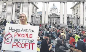  ??  ?? Hope: People staging a sit down protest at the ‘Raise the Roof’ rally outside Government buildings in Dublin yesterday.