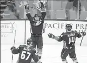  ?? Jae C. Hong Associated Press ?? THE DUCKS’ Cam Fowler, center, celebrates his winner with Adam Henrique and Rickard Rakell.