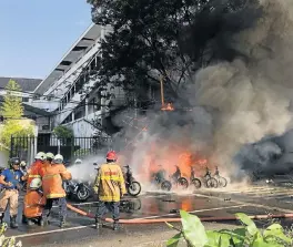  ?? /Antara Foto (See Page 4) ?? Church attack: Firefighte­rs try to extinguish a blaze following a blast at the Pentecost Church Central Surabaya in East Java, Indonesia on Sunday. A family of six launched suicide attacks at three churches in Surabaya, killing at least 13 people and...