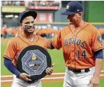  ?? Melissa Phillip / Houston Chronicle ?? Astros second baseman Jose Altuve holds his American League MVP award presented by manager A.J. Hinch.