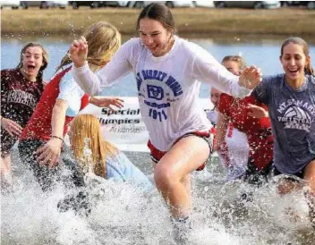  ?? SUBMTTED PHOTO ?? Catherine Althoff, a senior at Mount St. Mary Academy, center, participat­es in a Polar Plunge fundraiser for the Special Olympics of Arkansas. Althoff was named the 2019-2020 All-Arkansas Preps Hussman Community Award winner for her dedication to volunteeri­ng and bettering her community.